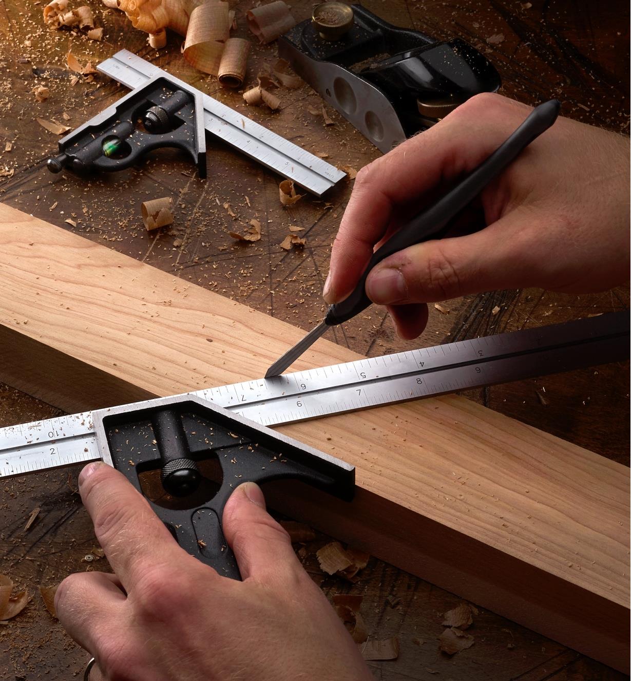 Using a 12" combination square and a marking knife to mark a miter cut on wooden stock