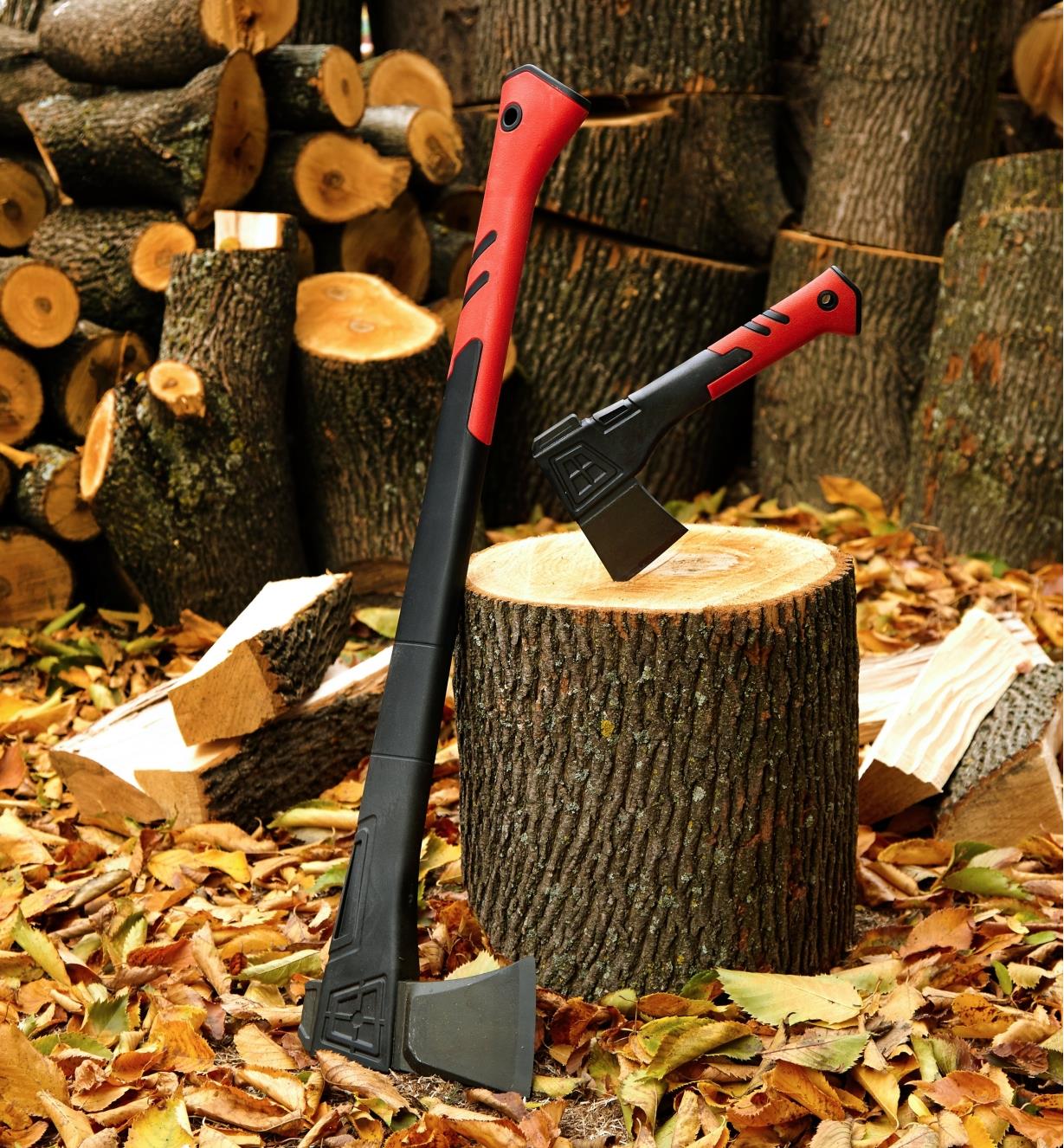 The hatchet set in the end of a piece of unsplit firewood, with the splitting axe leaning next to it