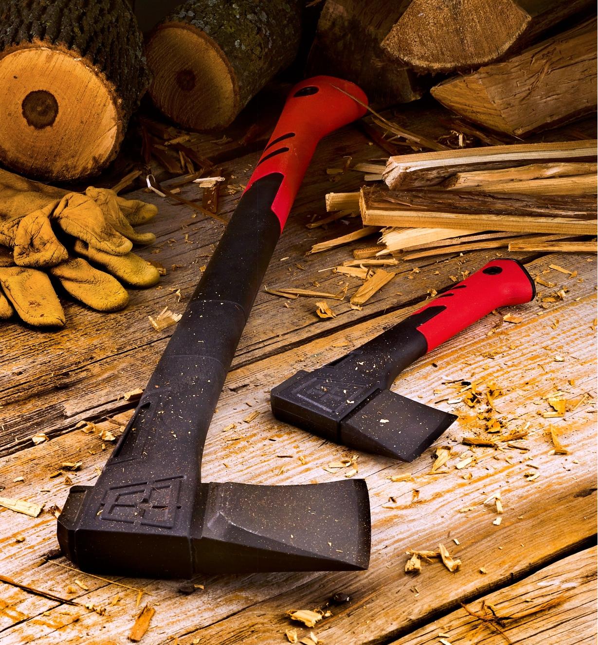 The splitting axe and the hatchet lying near some firewood and kindling