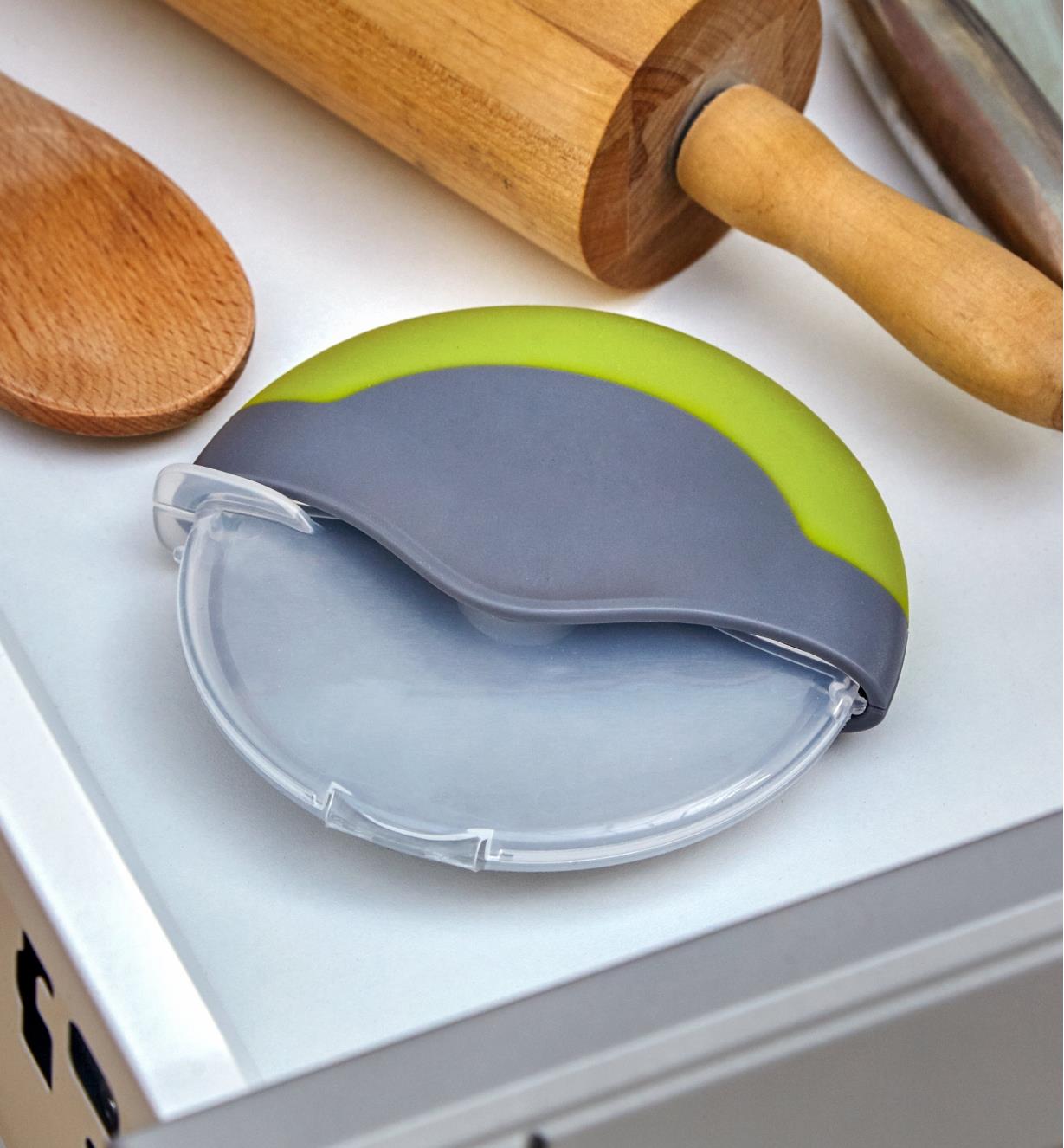 Blade guard in place on the pizza cutter for storing it in a kitchen drawer