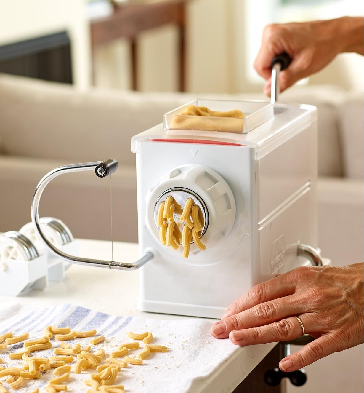 Fresh macaroni noodles being made with the Marcato pasta extruder