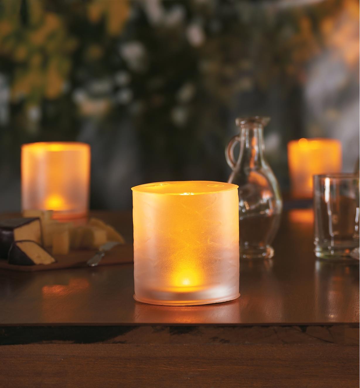 Three Inflatable Solar Candle Lanterns on an outdoor table