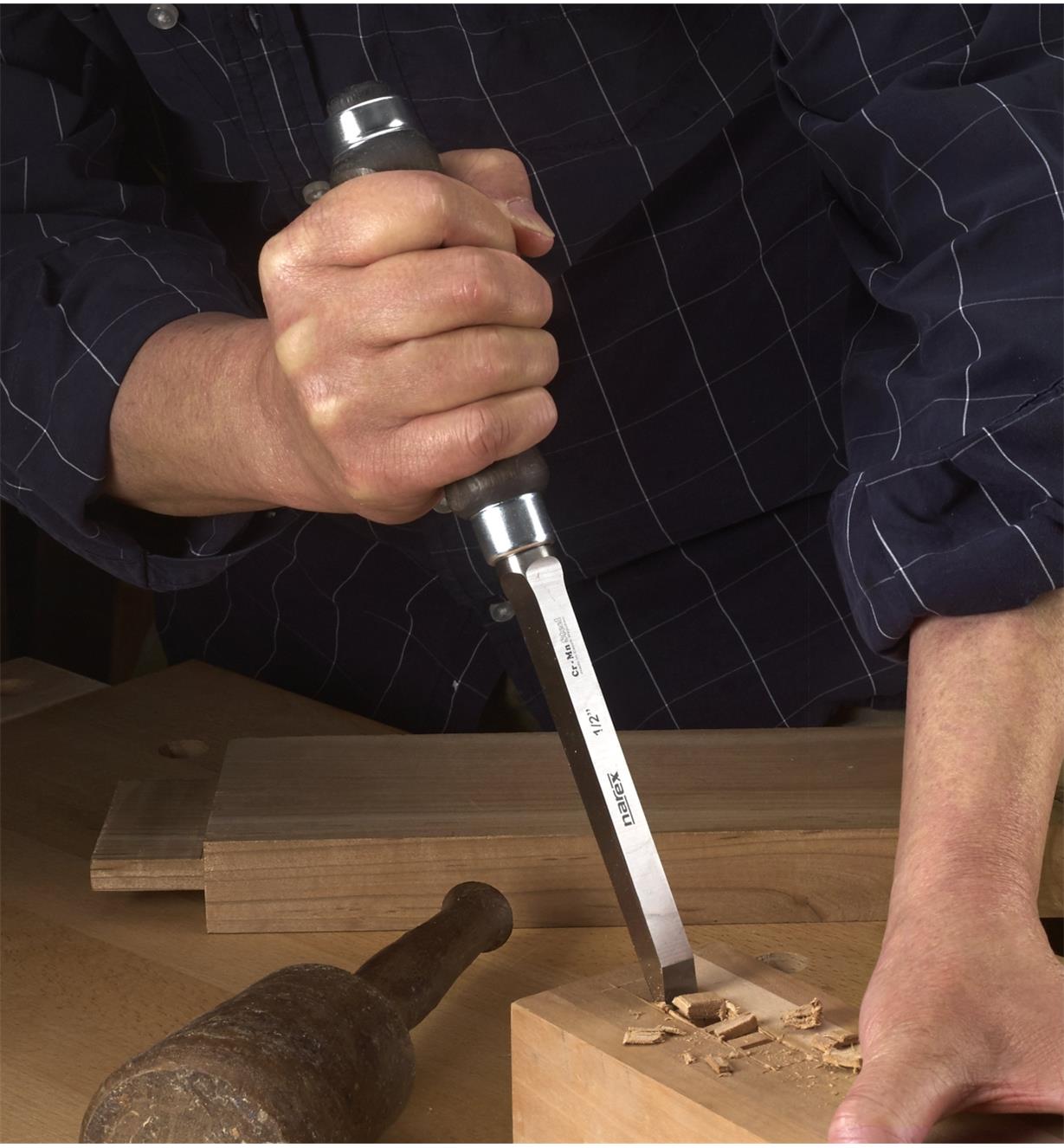 A woodworker chisels out a mortise with a Narex Mortise Chisel