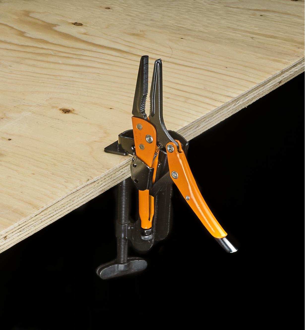 Grip-On long-jaw locking pliers in a job-site holder on the edge of a plywood sheet for use as a vise
