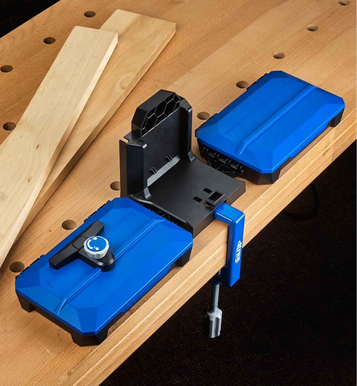 The Kreg docking station secured to a workbench with the included table clamp for greater stability