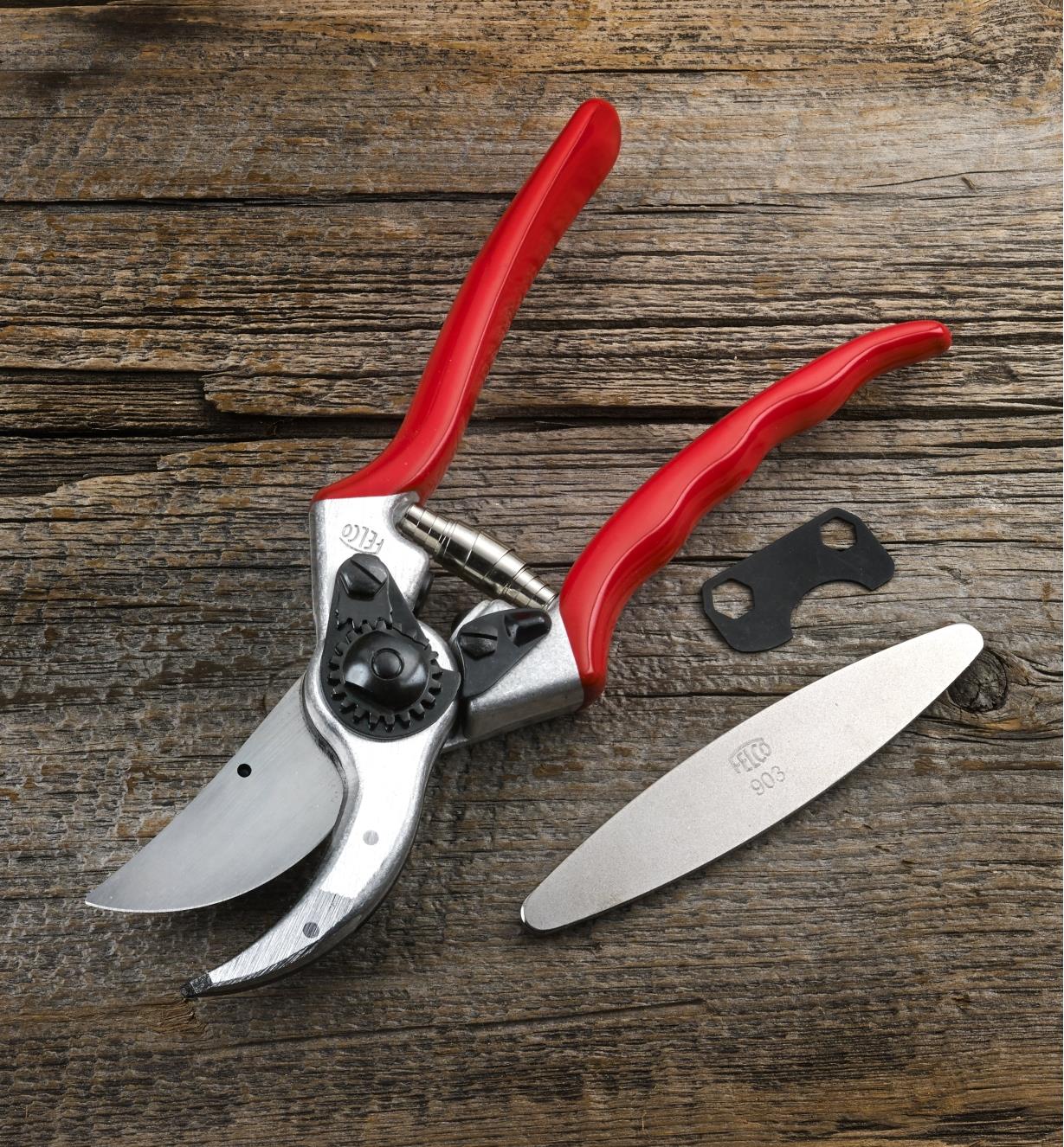 A Felco #2 pruner with the blade sharpener and an included adjustment key