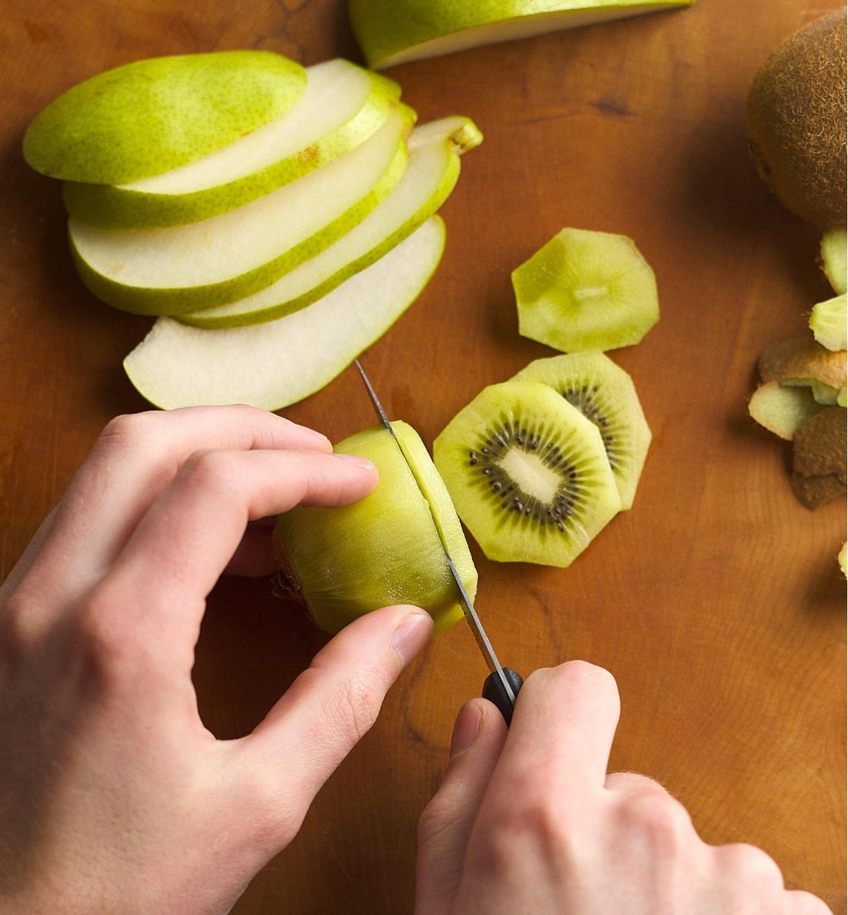 Slicing a kiwi fruit with the serrated paring knife