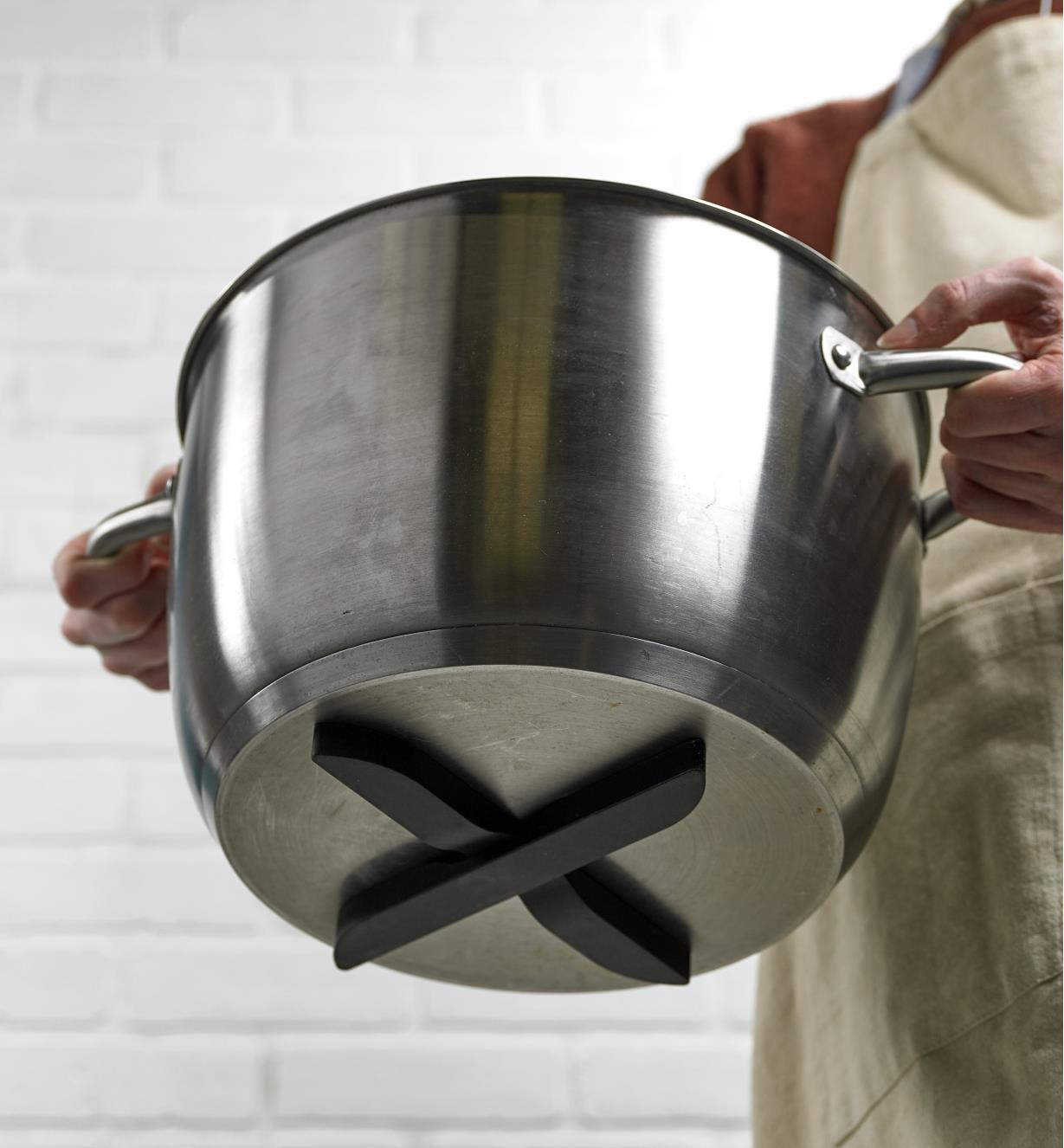 X-shaped magnetic trivet attached to the bottom of a steel pot