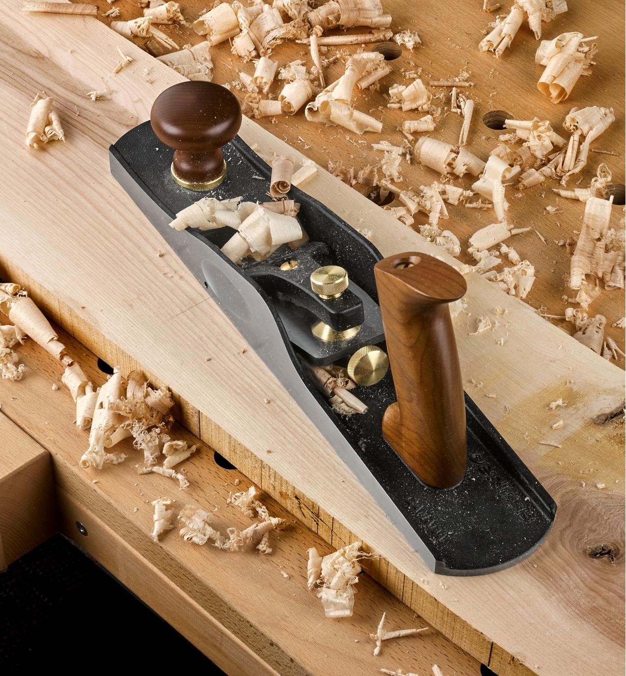 Veritas Low-Angle Jack Plane sitting on a board surrounded by wood shavings