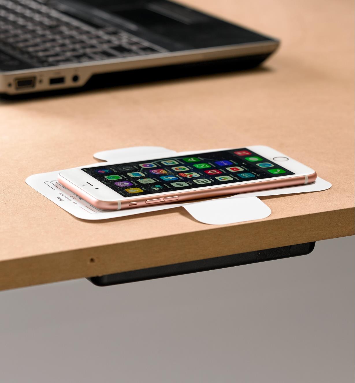 A calibration template guides phone placement on the surface above the wireless charger