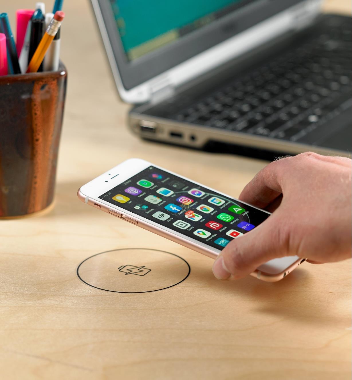 Placing a phone on a sticker marking the surface charging location of the wireless charger