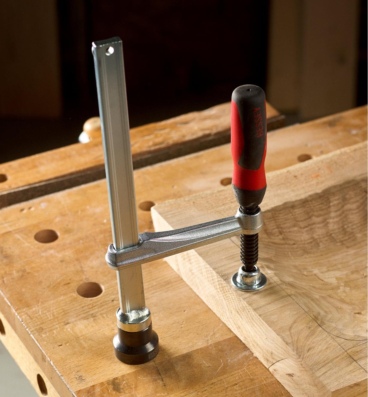 Bessey hold-down clamp clamping a wooden tray to a workbench