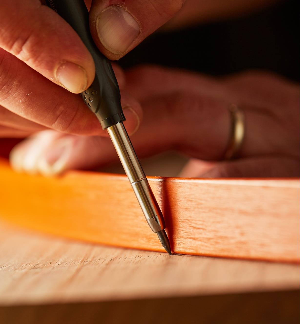 Drawing a curved line on wood using a Pica-Dry Mechanical Pencil and a drawing bow