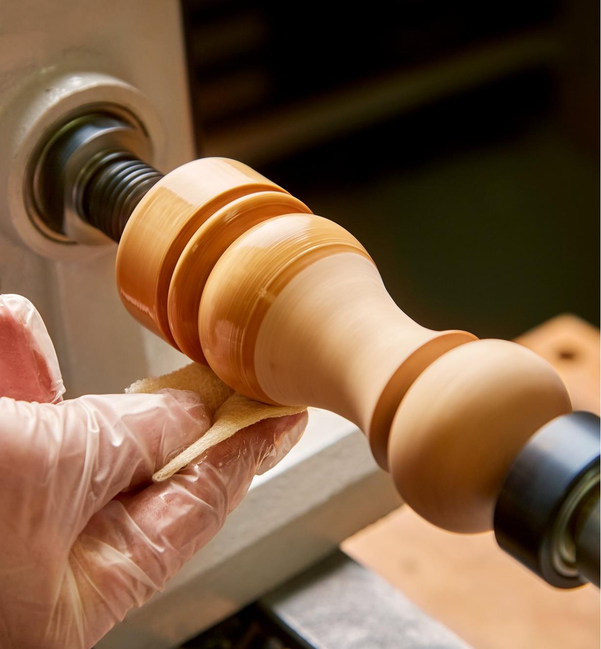 Applying General wood bowl finish to a workpiece mounted on a lathe