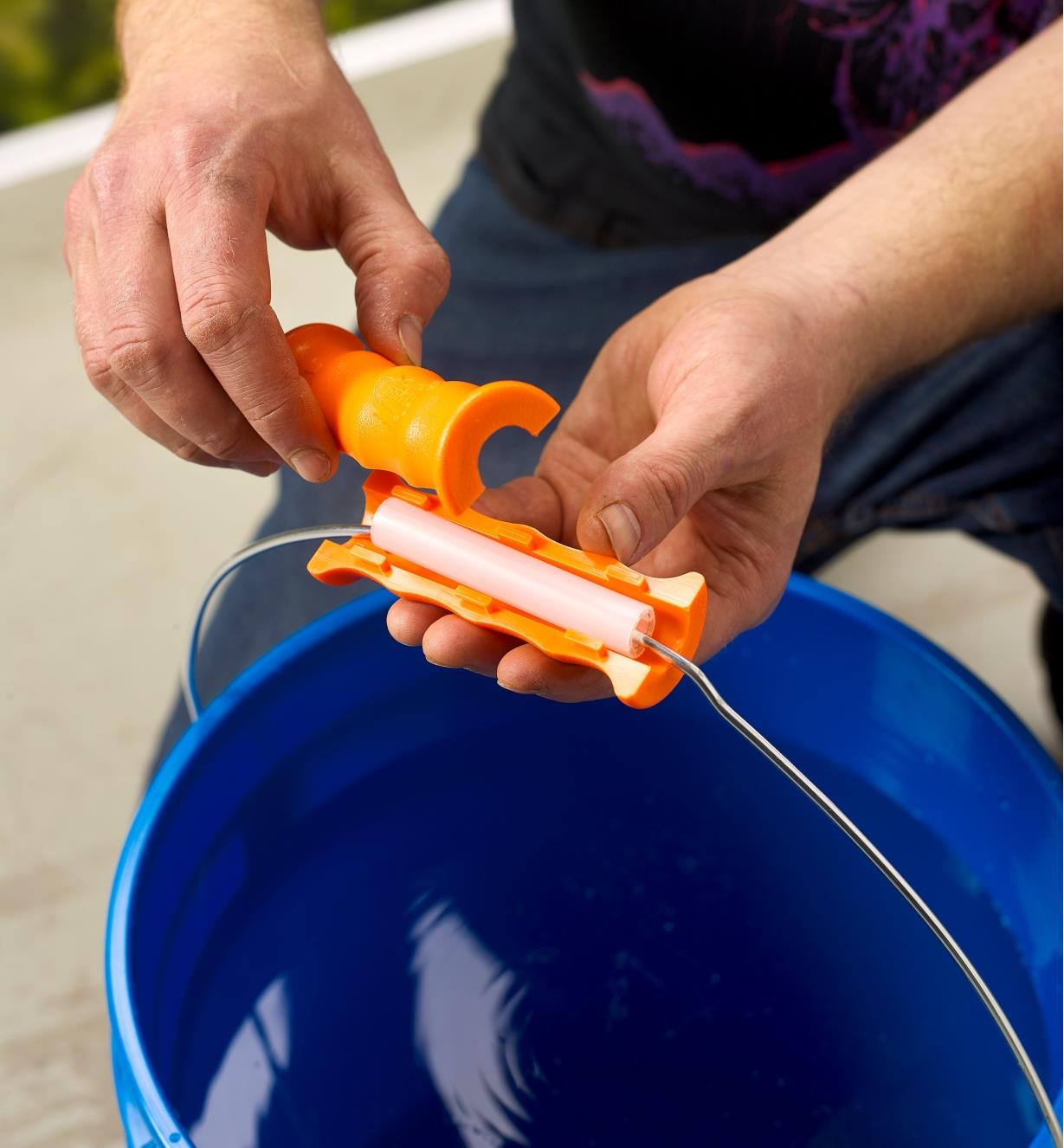 Clipping a Bigg Gripp bucket handle over a plastic bucket handle