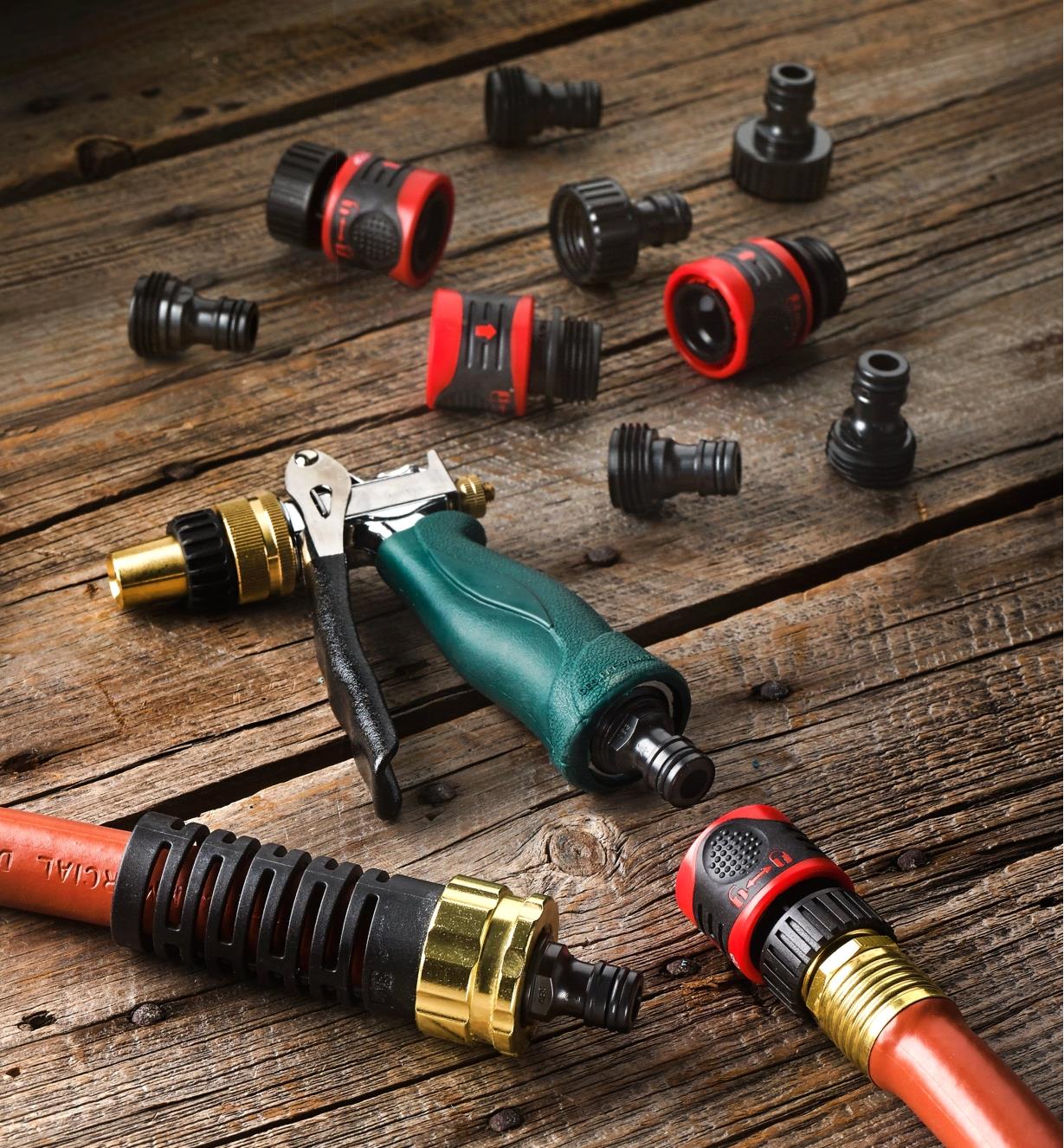 All components of the 12-piece quick-connect set shown with a sprayer and two ends of a garden hose