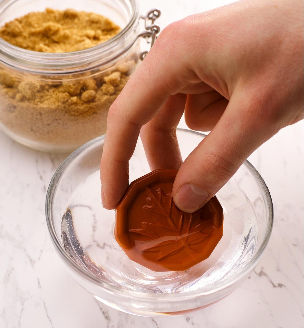 Placing a brown sugar saver in water to soak