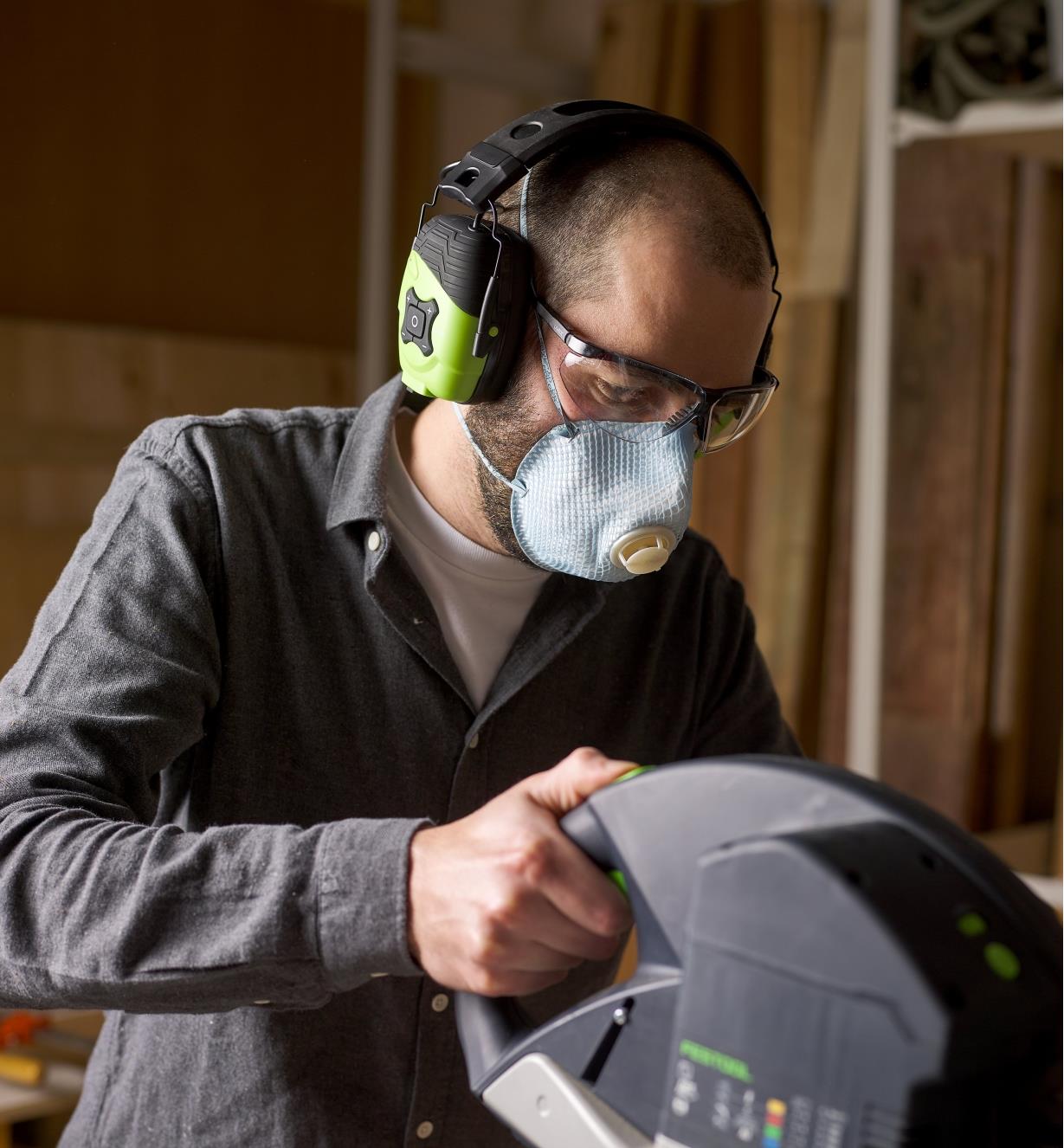Operating a miter saw while wearing the ISOTunes LINK Aware earmuff hearing protectors