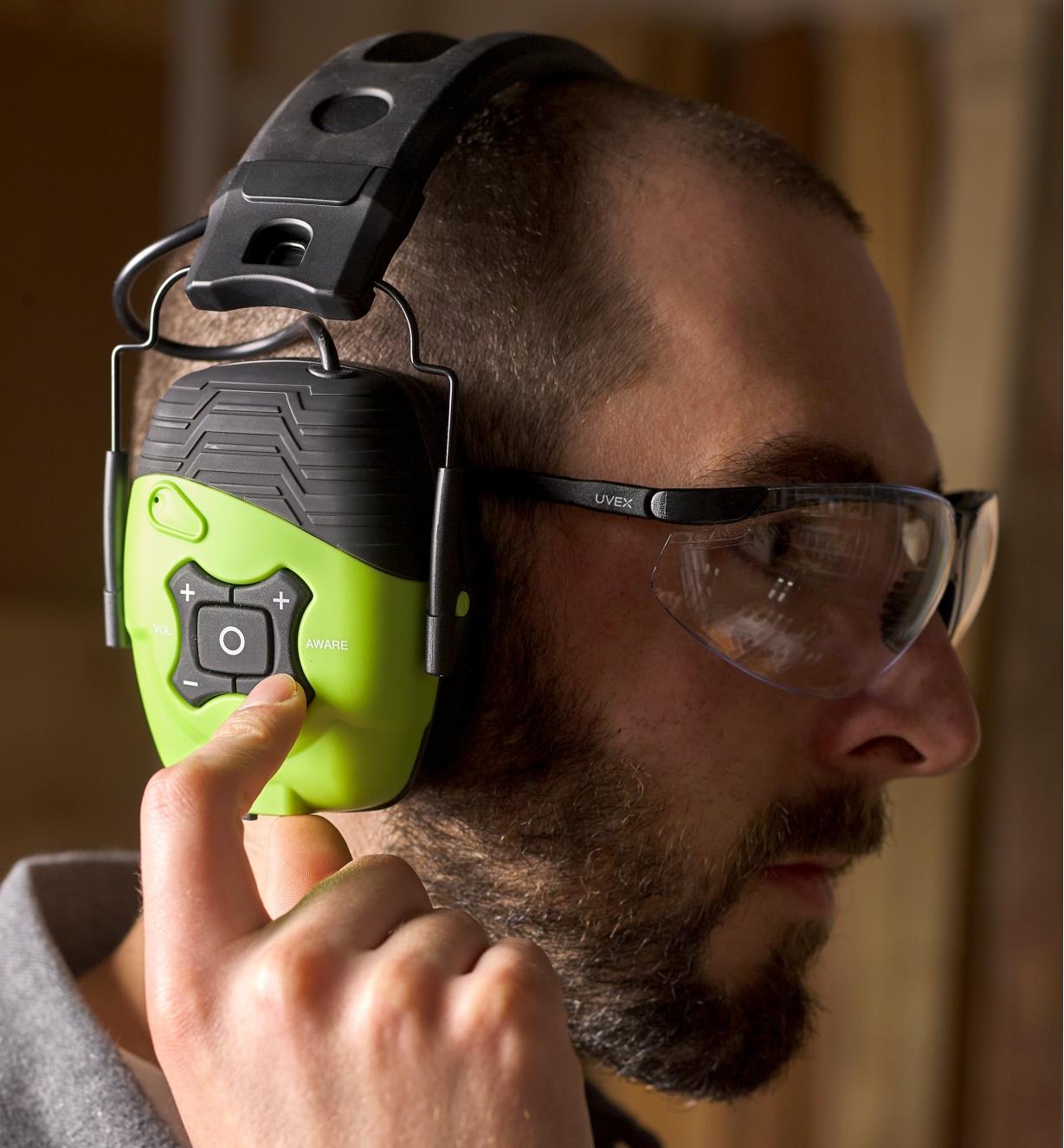 Operating the volume control buttons on the ISOTunes LINK Aware earmuff hearing protectors