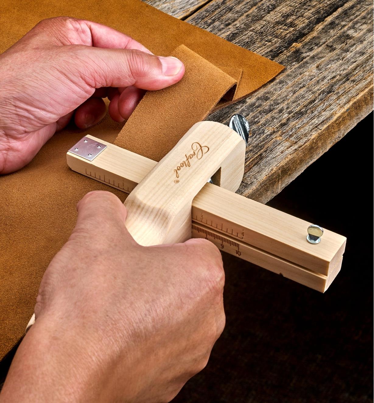 Using the leather strap cutter to cut a band of a consistent width from a larger piece of leather