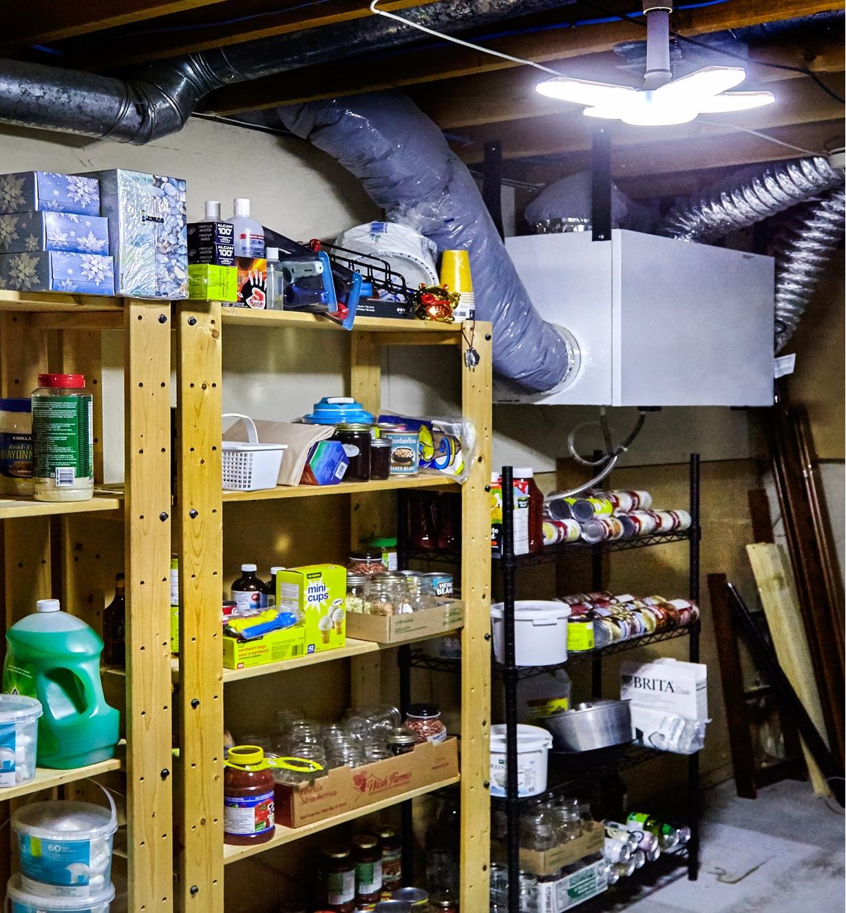 A directional LED ceiling light used to illuminate a basement storage area