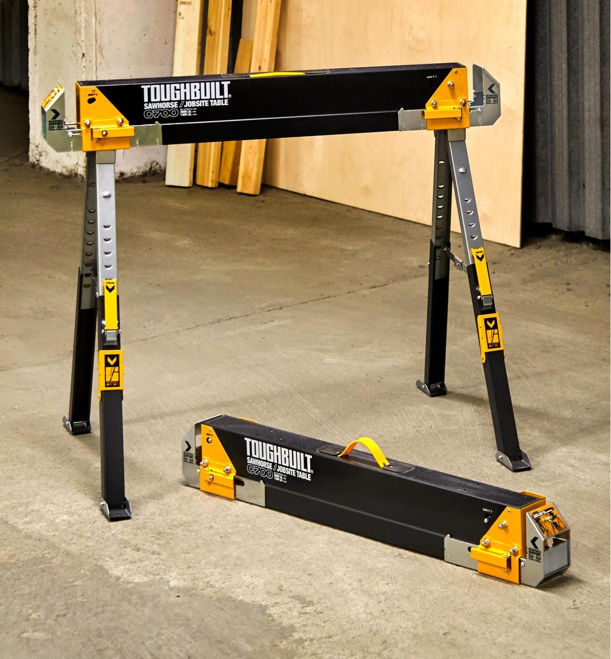 A pair of C700 sawhorses shown in a workshop, one ready for use, the other folded down for storage