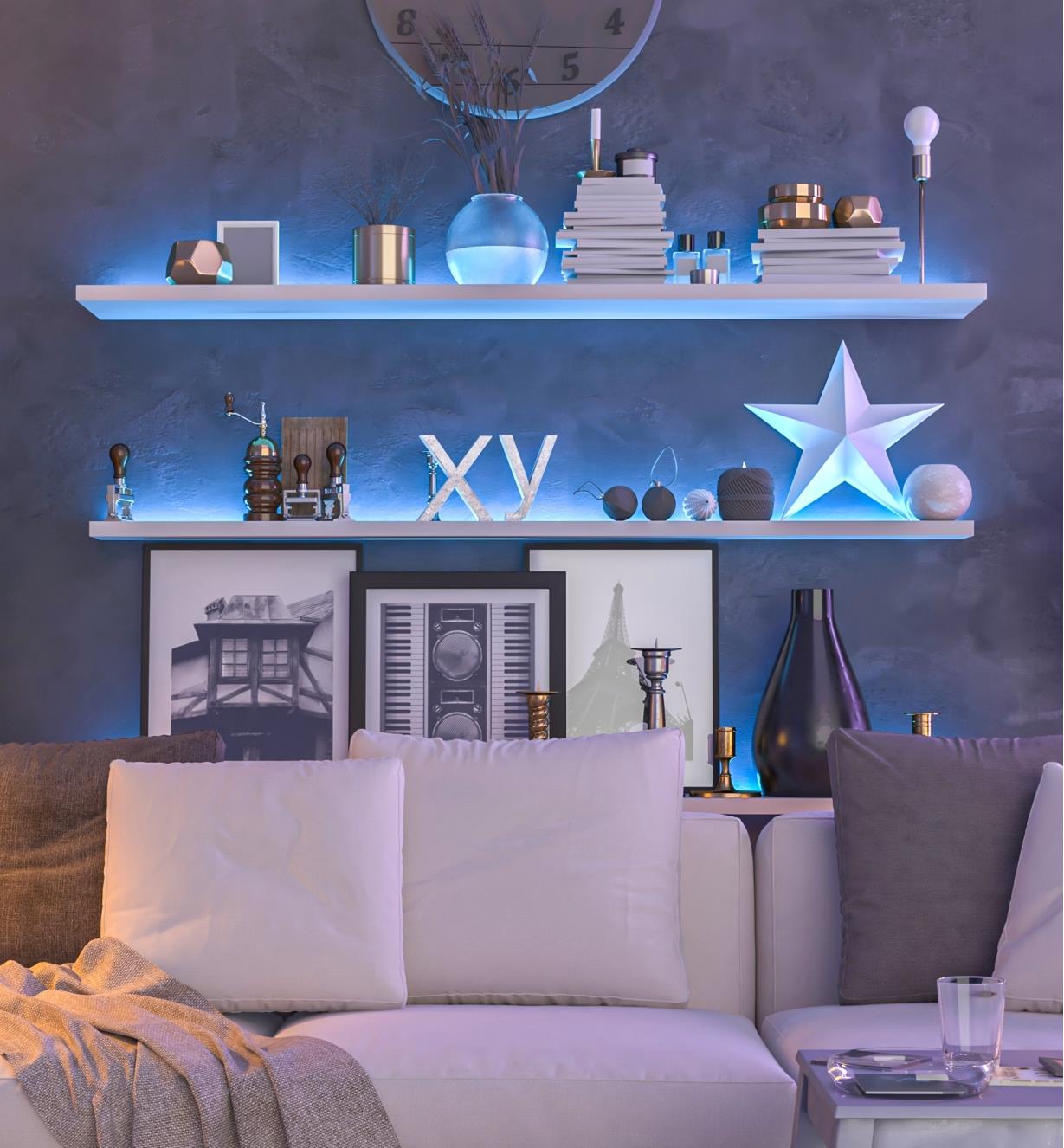 A sofa with a set of shelves above it, illuminated with blue light