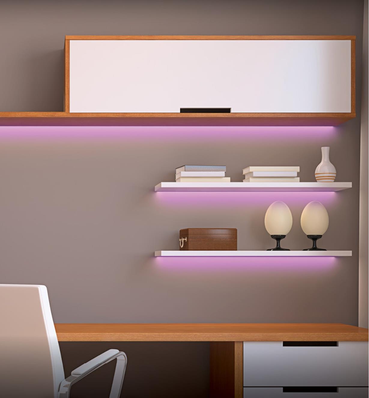 A wall of shelves highlighted by pink glow
