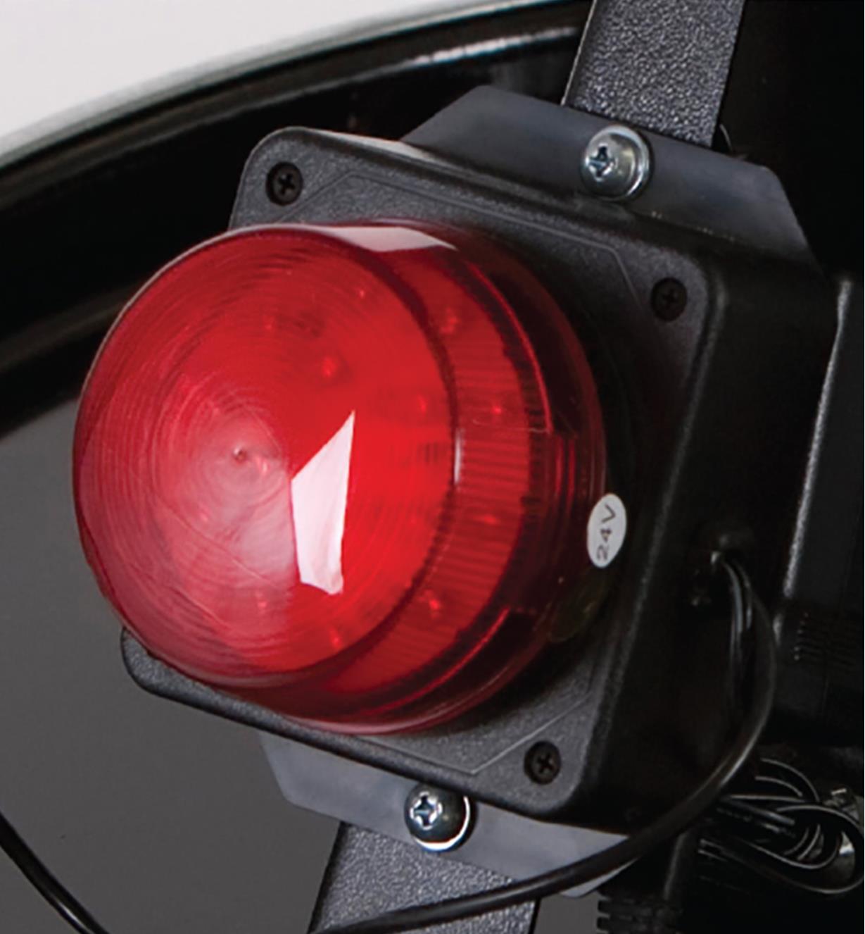 A red light bolted to the frame of the Oneida V-1500 dust collector