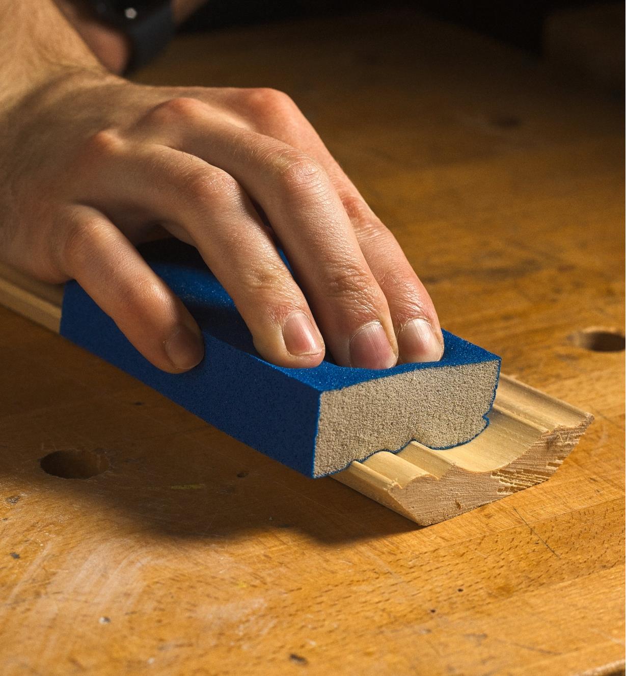 Sanding a piece of molding with a Norton ProSand Sanding Sponge