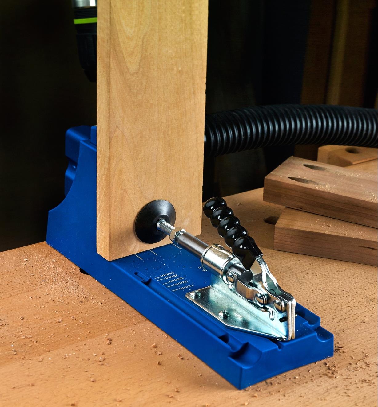 A rear view of a K4 metric jig in use, showing how the workpiece is held in place for drilling