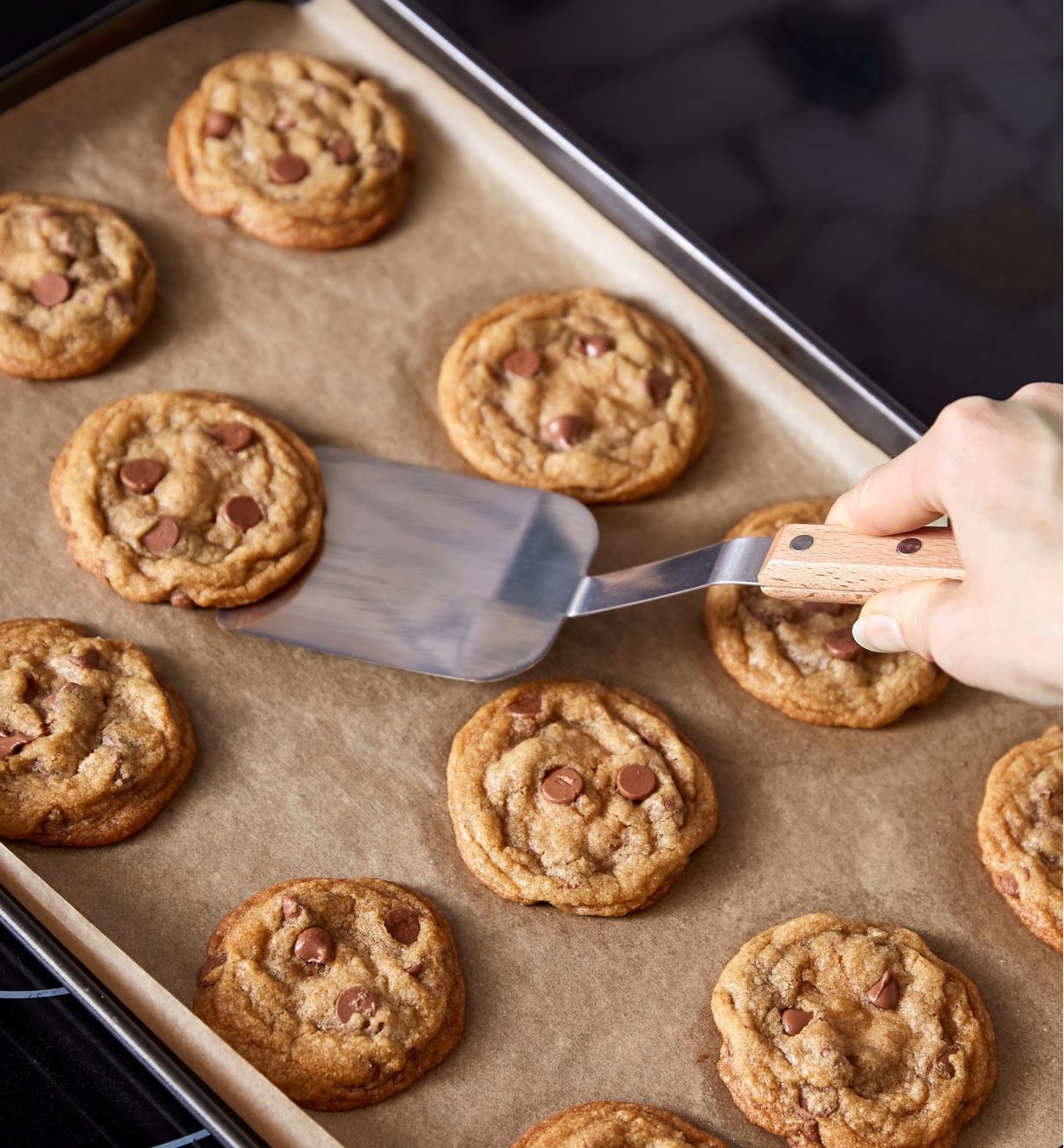 Stainless-Steel Spatula sliding under a cookie on a baking sheet