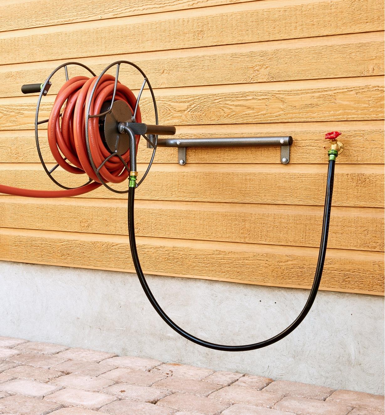 Hose Reel holding a hose, mounted on a wall in the open position