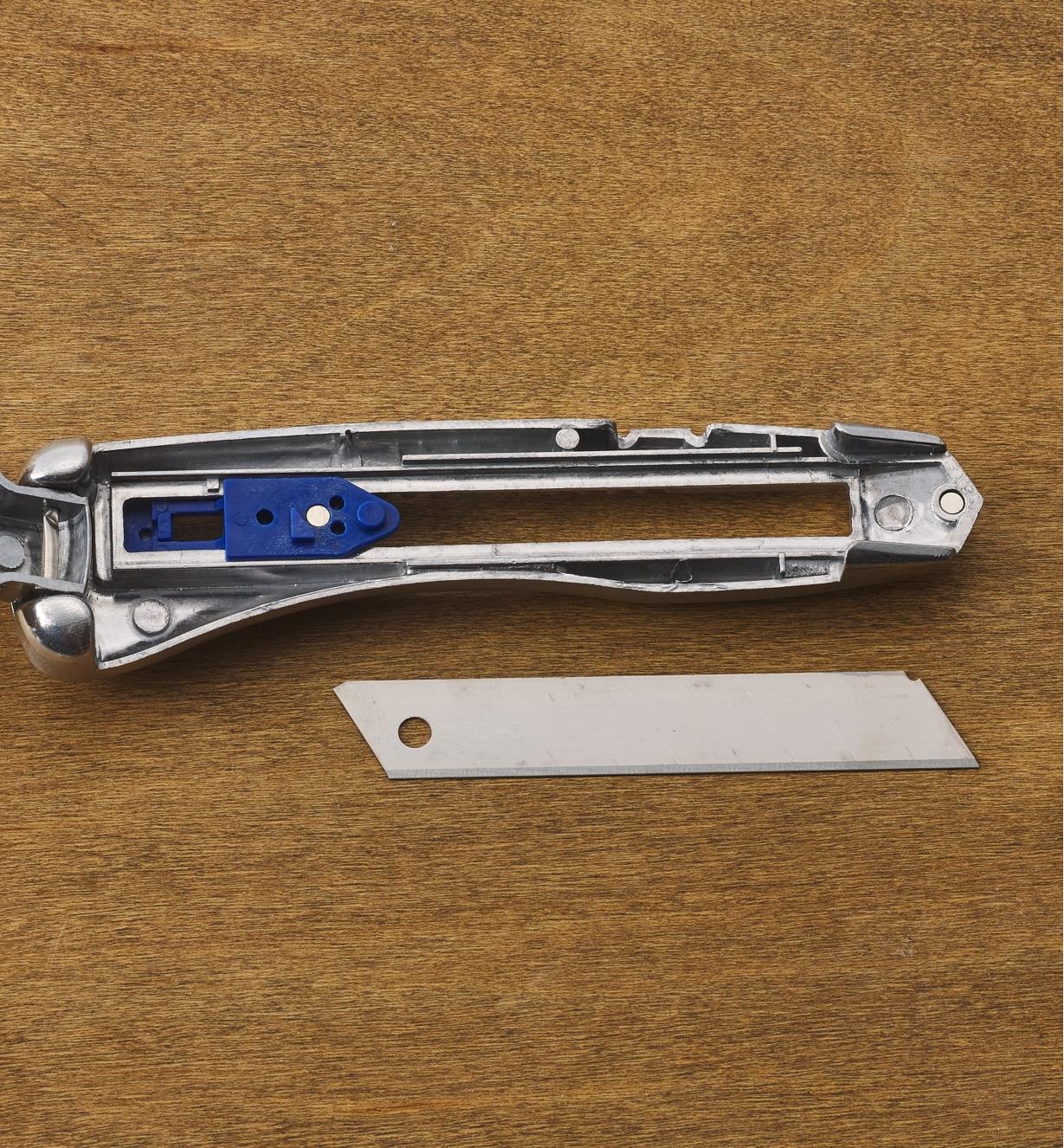 The Delphin snap-off blade knife opened with the blade removed to show the internal mechanism