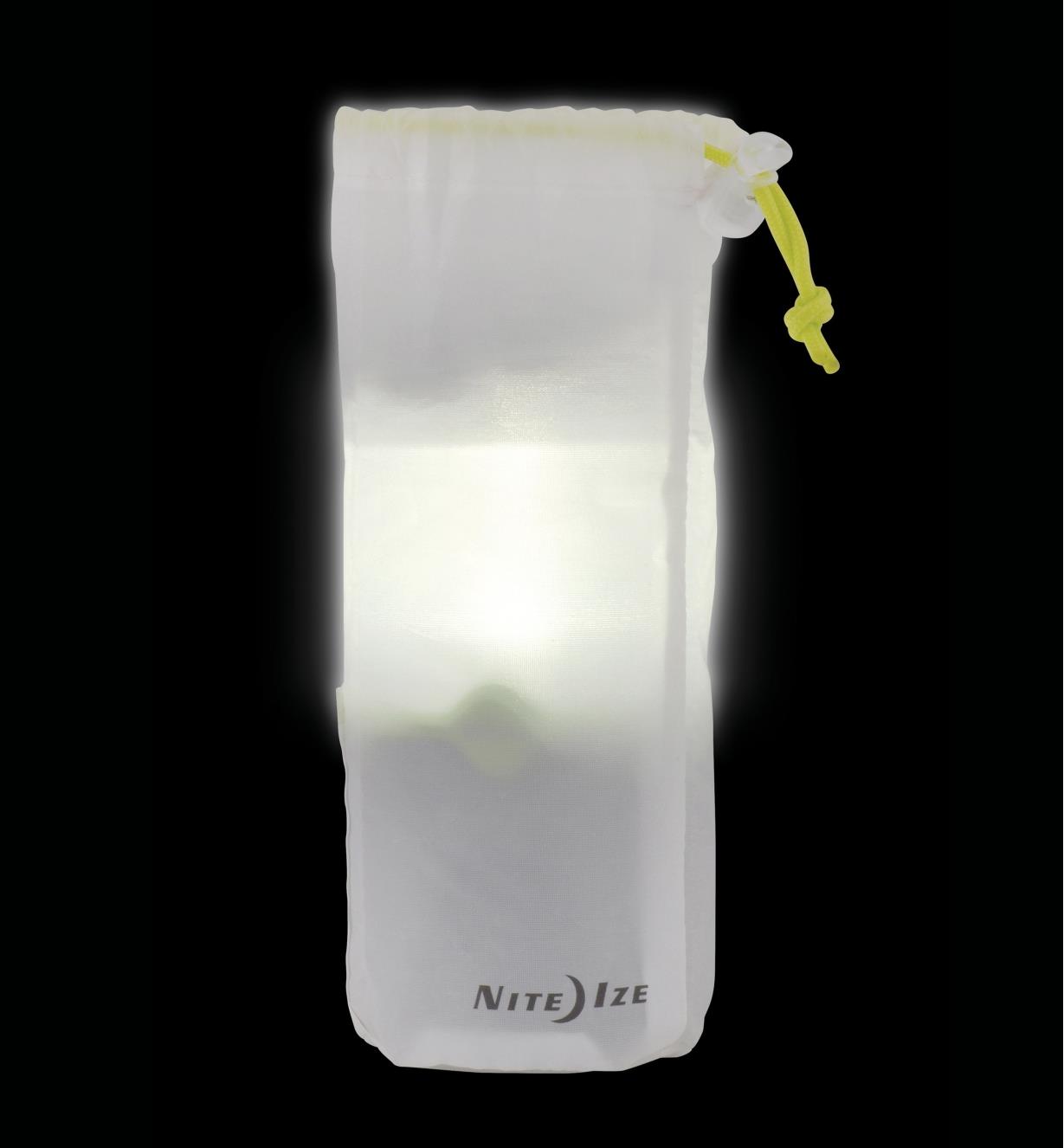 A translucent carrying bag with a drawstring holds the lantern