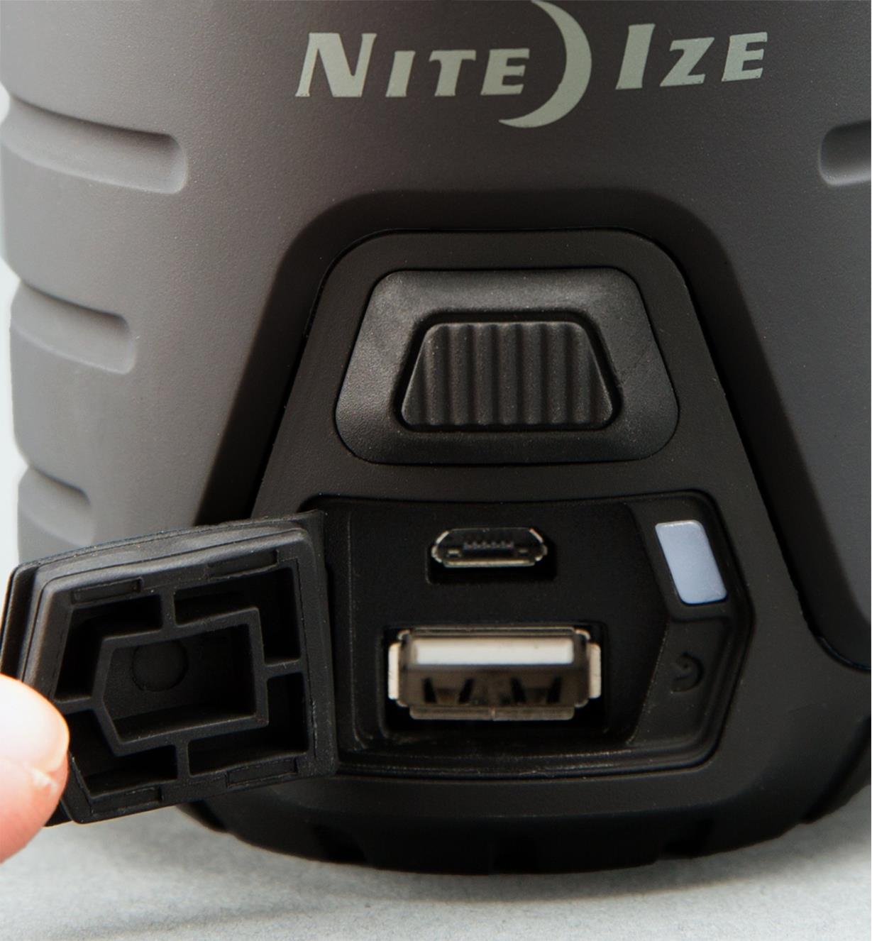 A panel on the base of the lantern is open to show a USB port and micro input for charging