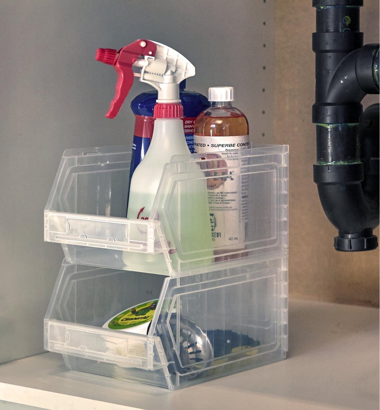 Two stackable light-duty storage bins used under a sink to hold cleaning supplies