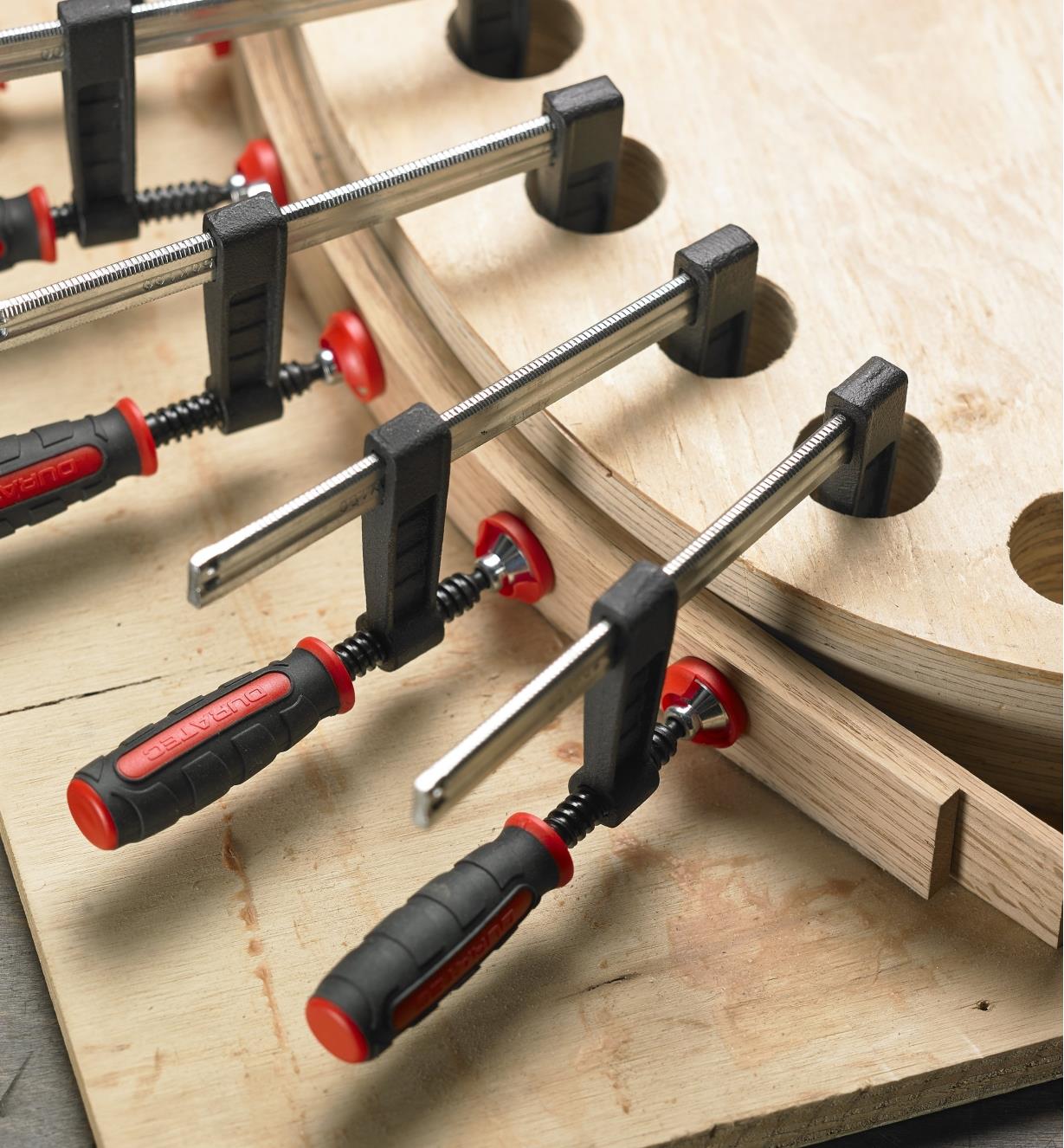 Multiple 4" light-duty fast-acting clamps grip a bent lamination