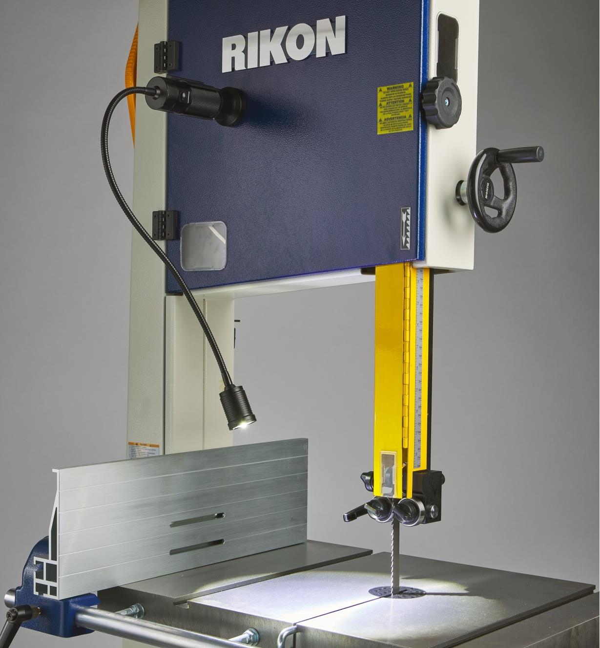 A flex-neck LED work light mounted on the Rikon 10-326 and extended over the saw’s machine table