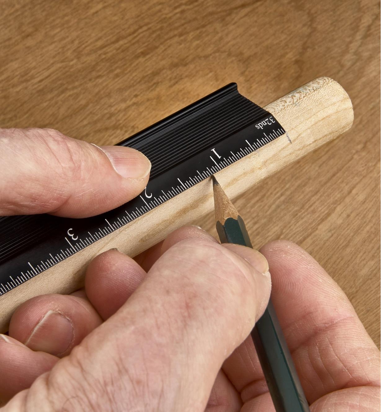 Using a pencil to mark a dowel registered in the inside corner of a Veritas edge rule
