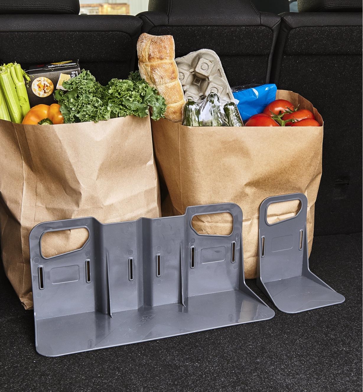 Cargo holder brackets holding grocery bags upright in a car’s cargo area