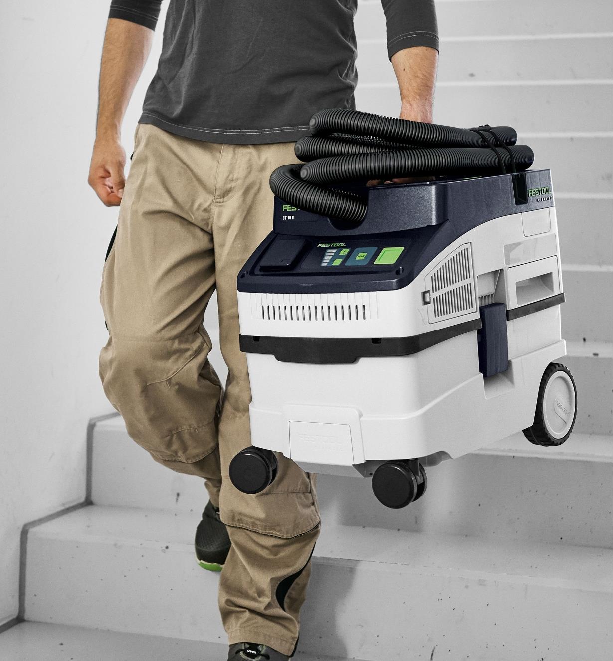 Festool CT 15 E Mobile Dust Extractor being carried downstairs