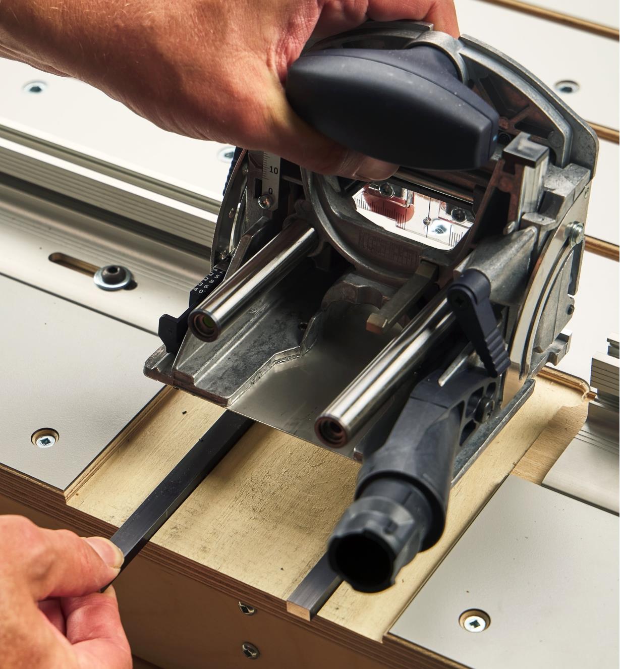 Installing shims in the table slots of a Veritas Domino joinery table to create a vertical offset
