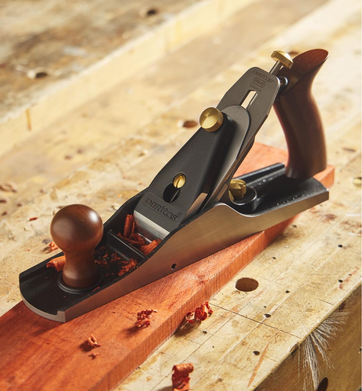 A Veritas #5 1/4W bench plane used to plane a wooden board