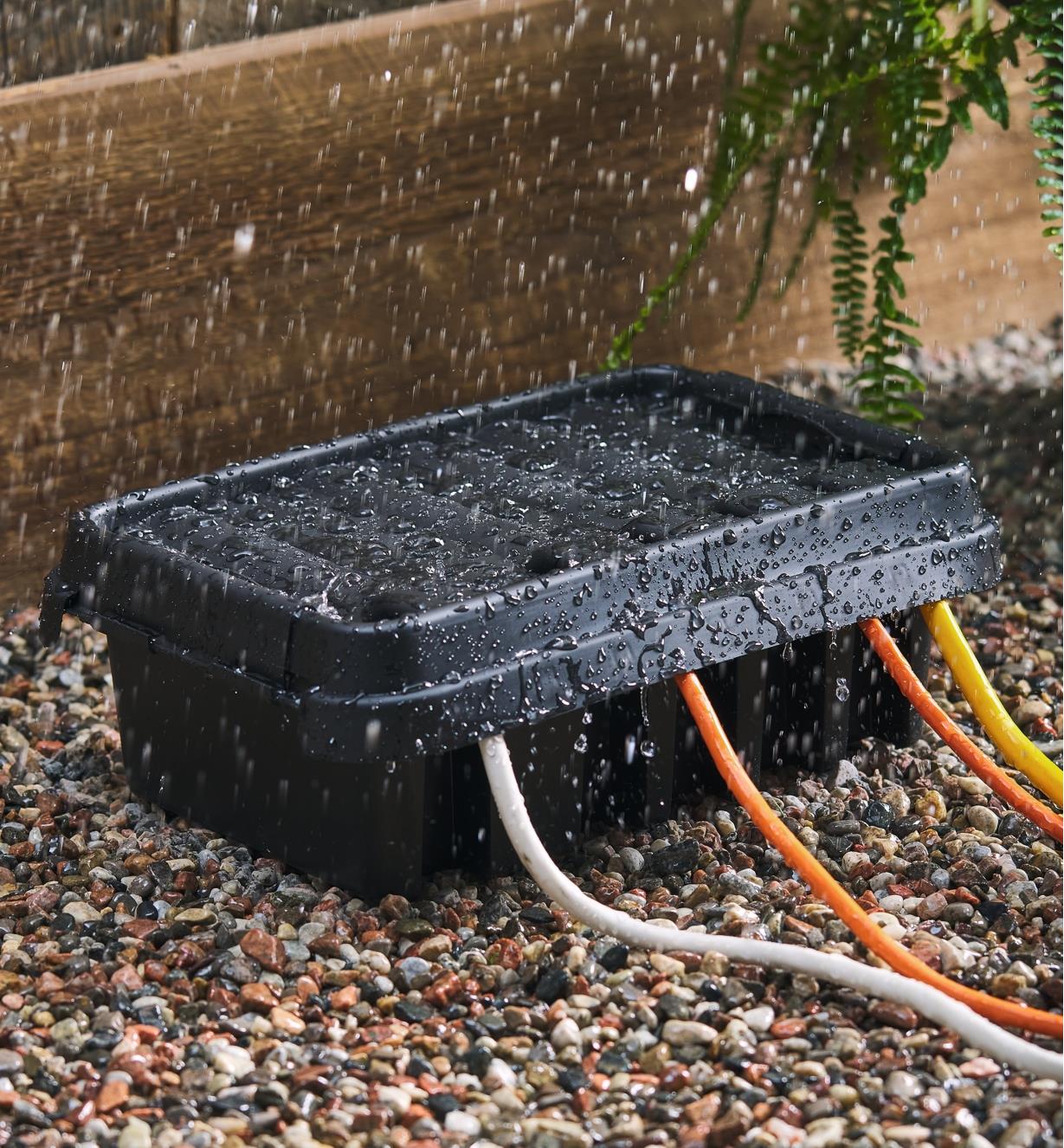 A closed SockitBox protects four extension cords from the rain