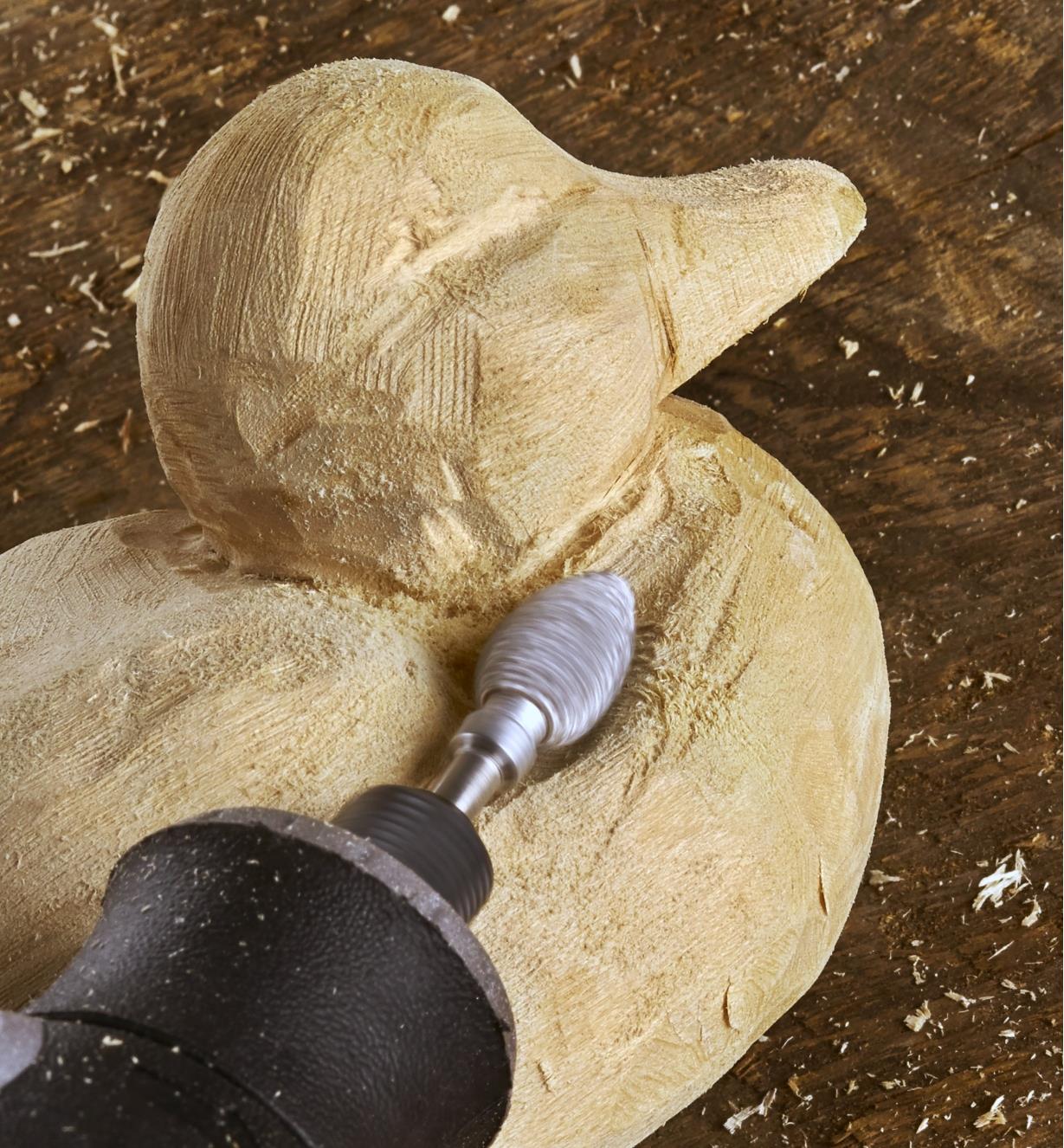Using a flame-shaped Kutzall rotary carving burr to sculpt the neck contours of a duck carving