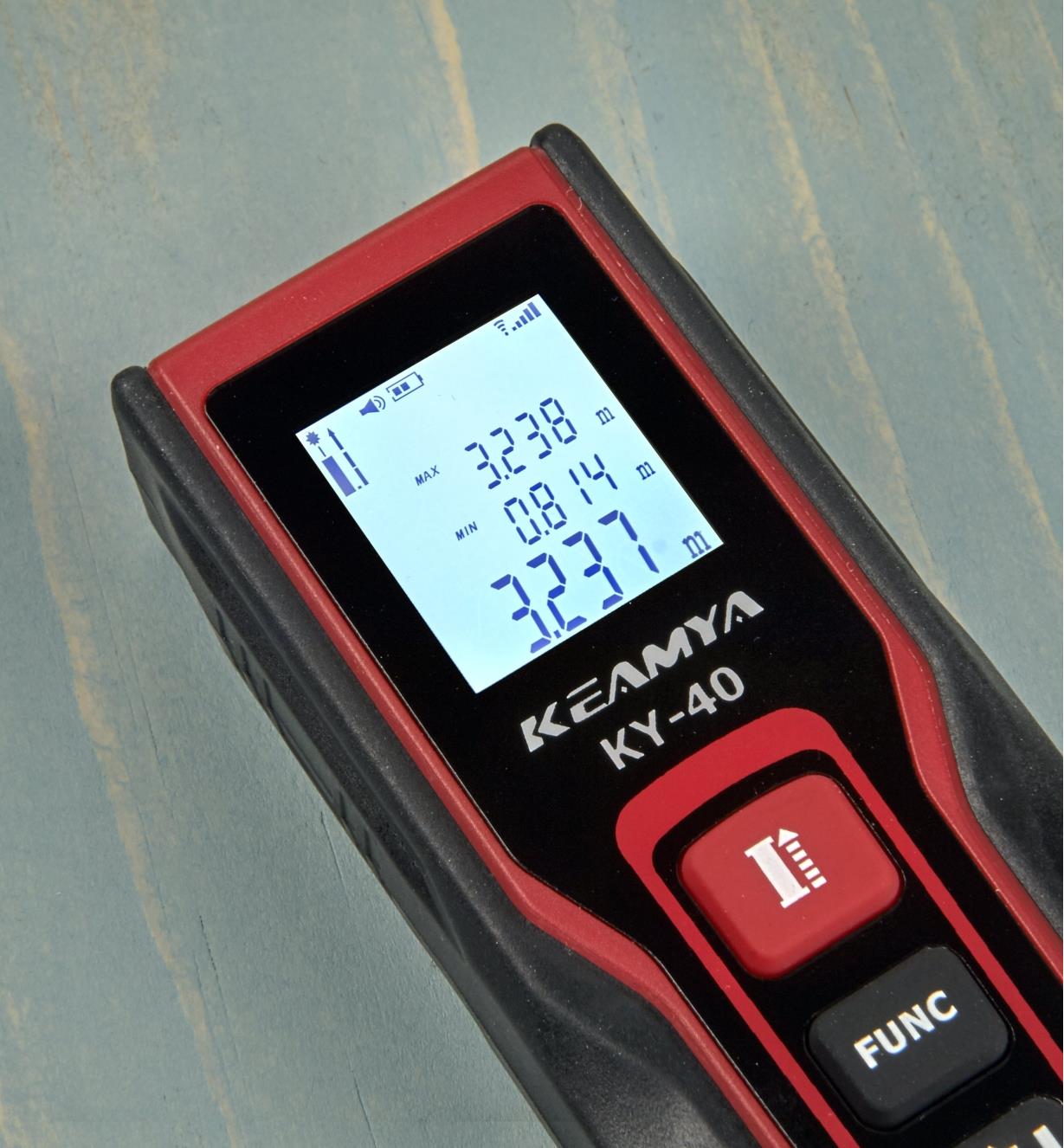 A pocket laser measure displays measurements in metric