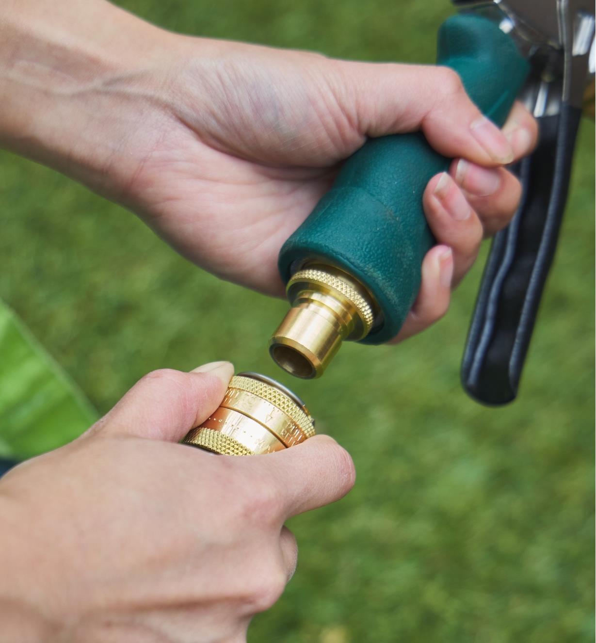 Connecting a garden hose to a spray nozzle using a brass quick-connect coupler