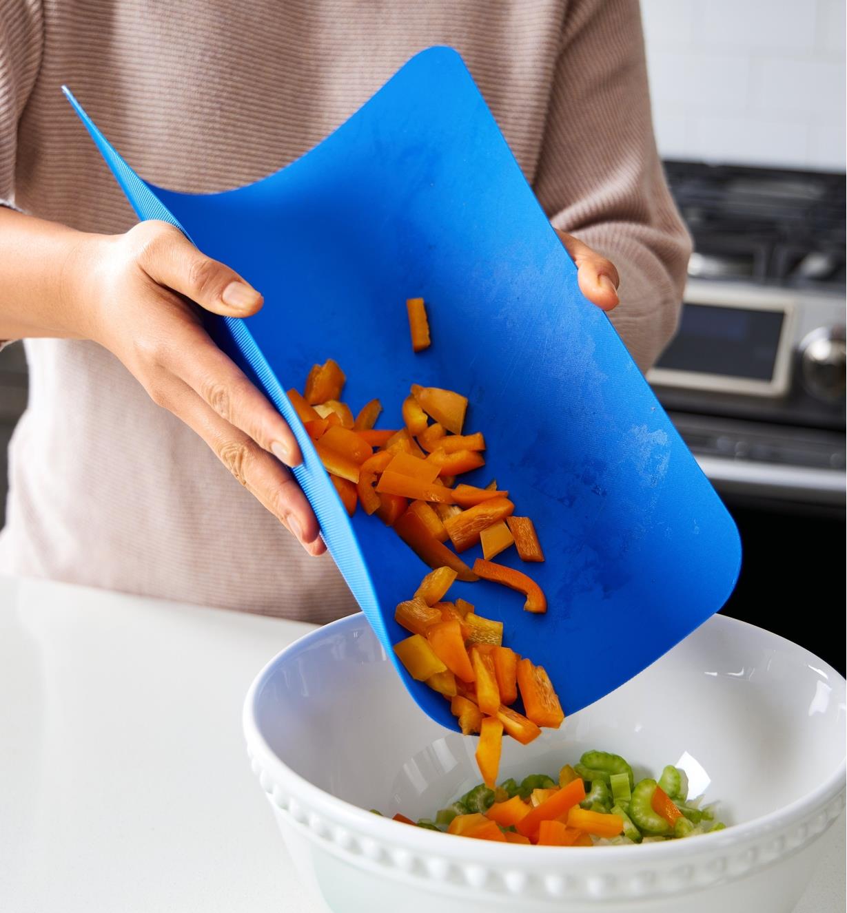 Transferring chopped food items from a flexible cutting mat to a bowl