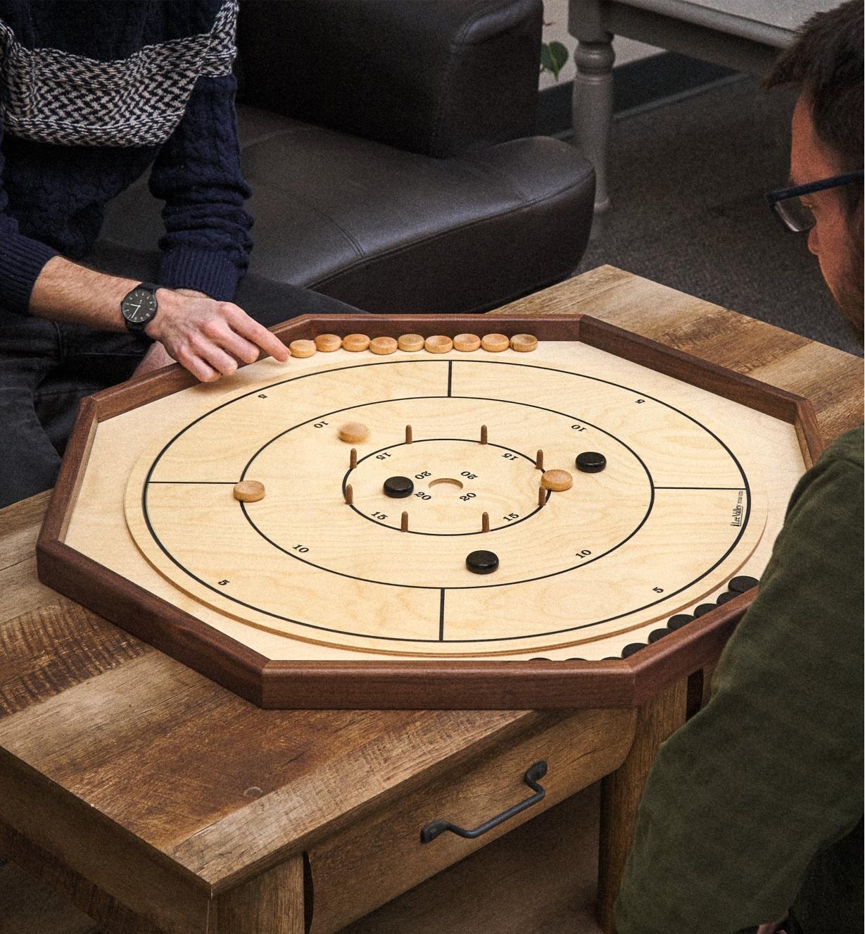 Playing crokinole on a deluxe crokinole, checker and chess board